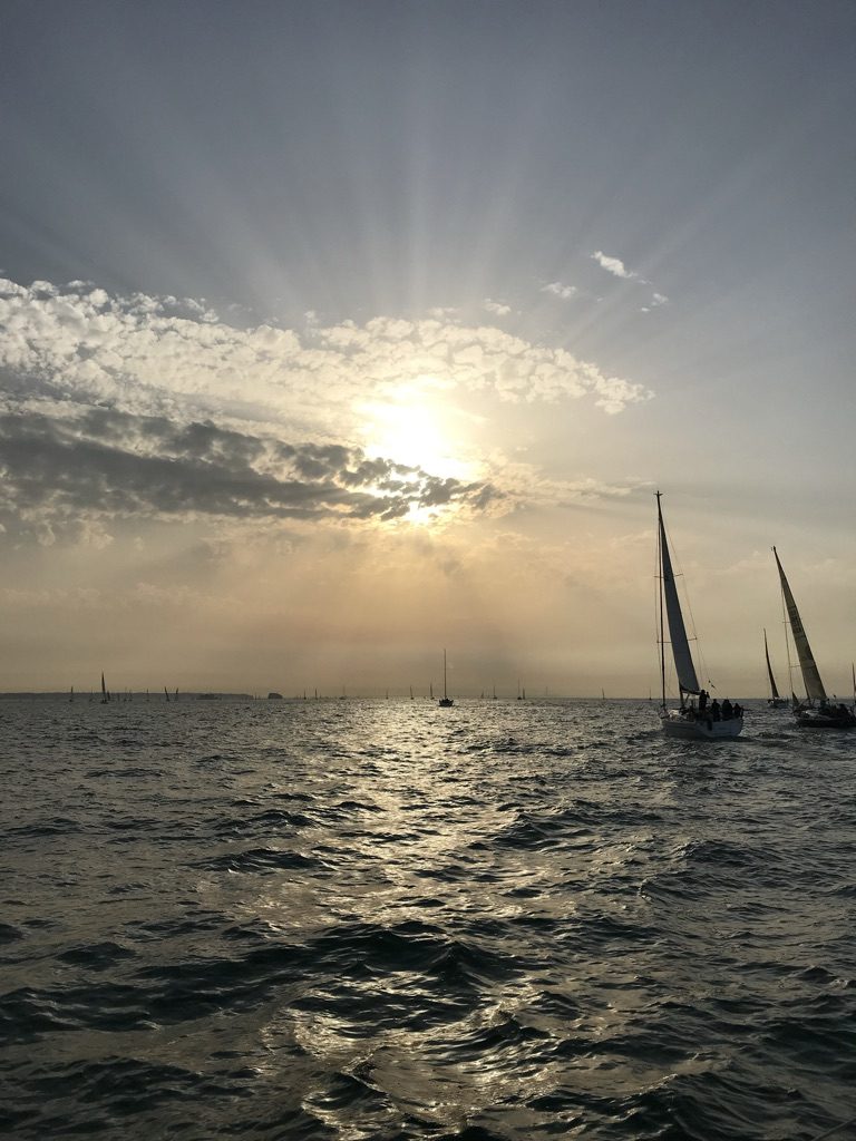 Yachts racing into the evening sun